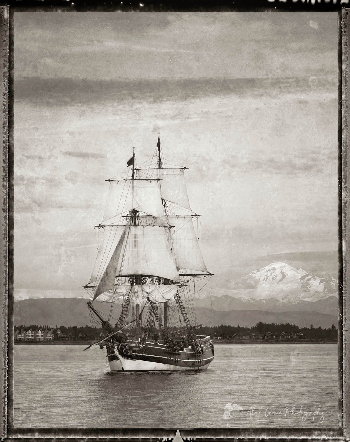 Lady Washington in Semiahmoo Bay, Washington. Mount Baker is in the distance. A historic replica of the original 18th Century brig. Owned and operated by the Grays Harbor Historical Seaport, Aberdeen, Washington #62510bwp