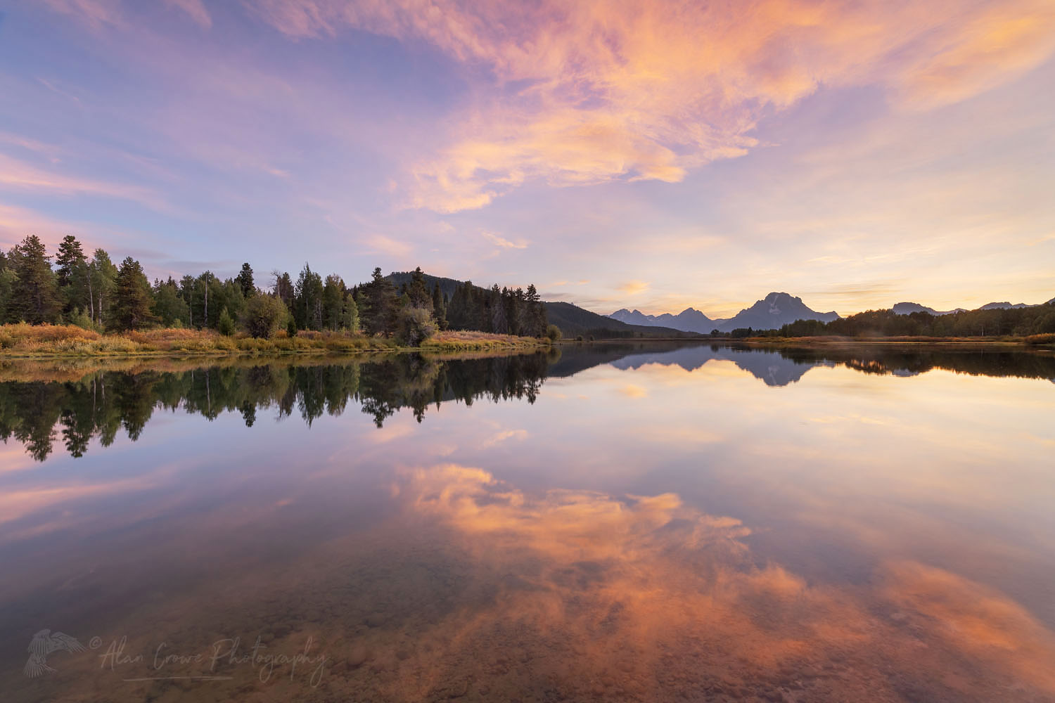 Clouds glowing red and orange in the light of the setting sun reflected in still waters of the Snake River at Oxbow Bend, Grand Teton National Park Wyoming #67564