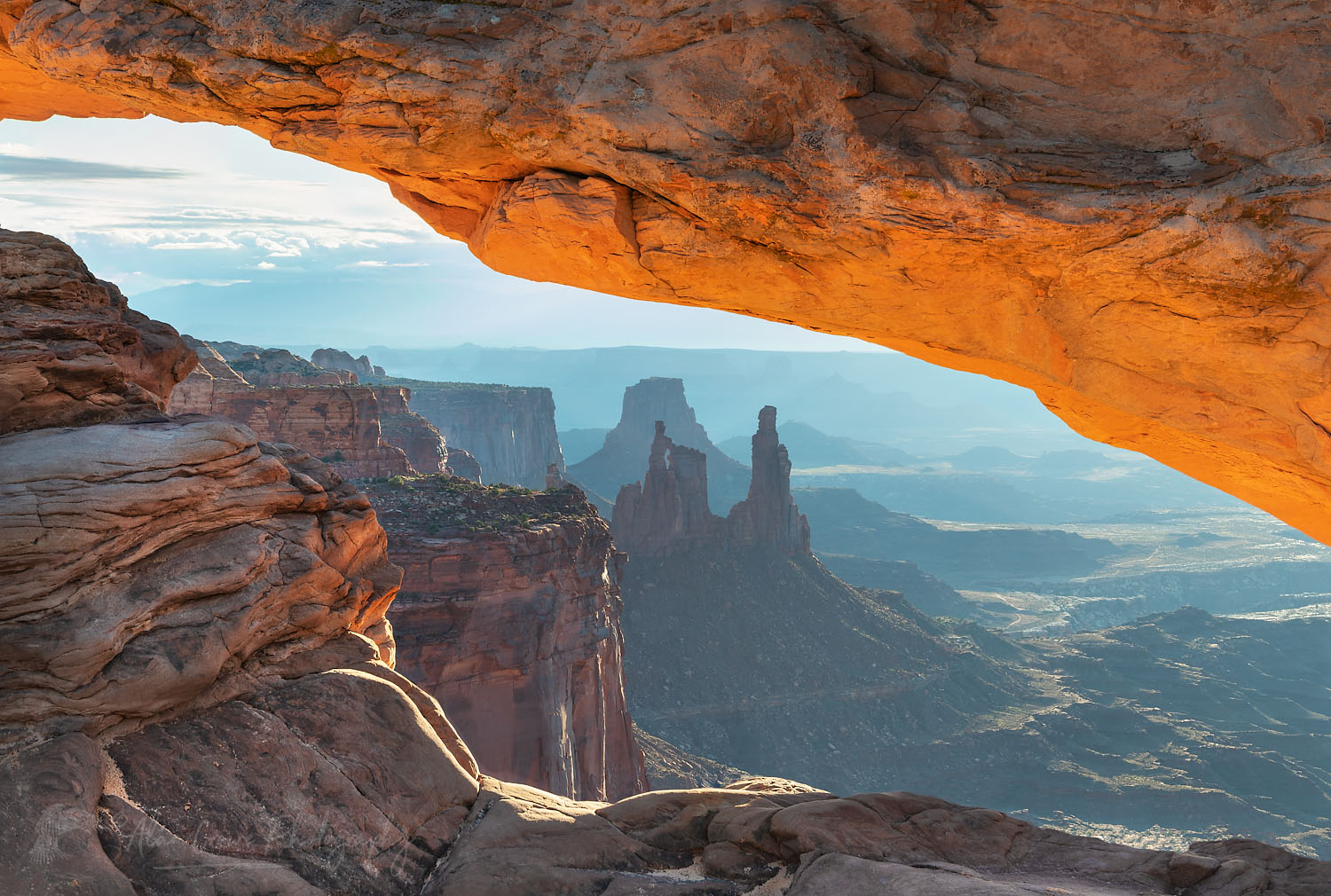 Mesa Arch Canyonlands National Park. Washer Woman Arch, Monster, and Airport Towers are in the distance. #74554