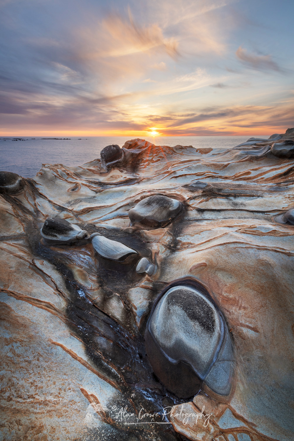 Sunset over Mineral concretions on cliffs of Shore Acres State Park Oregon #83012