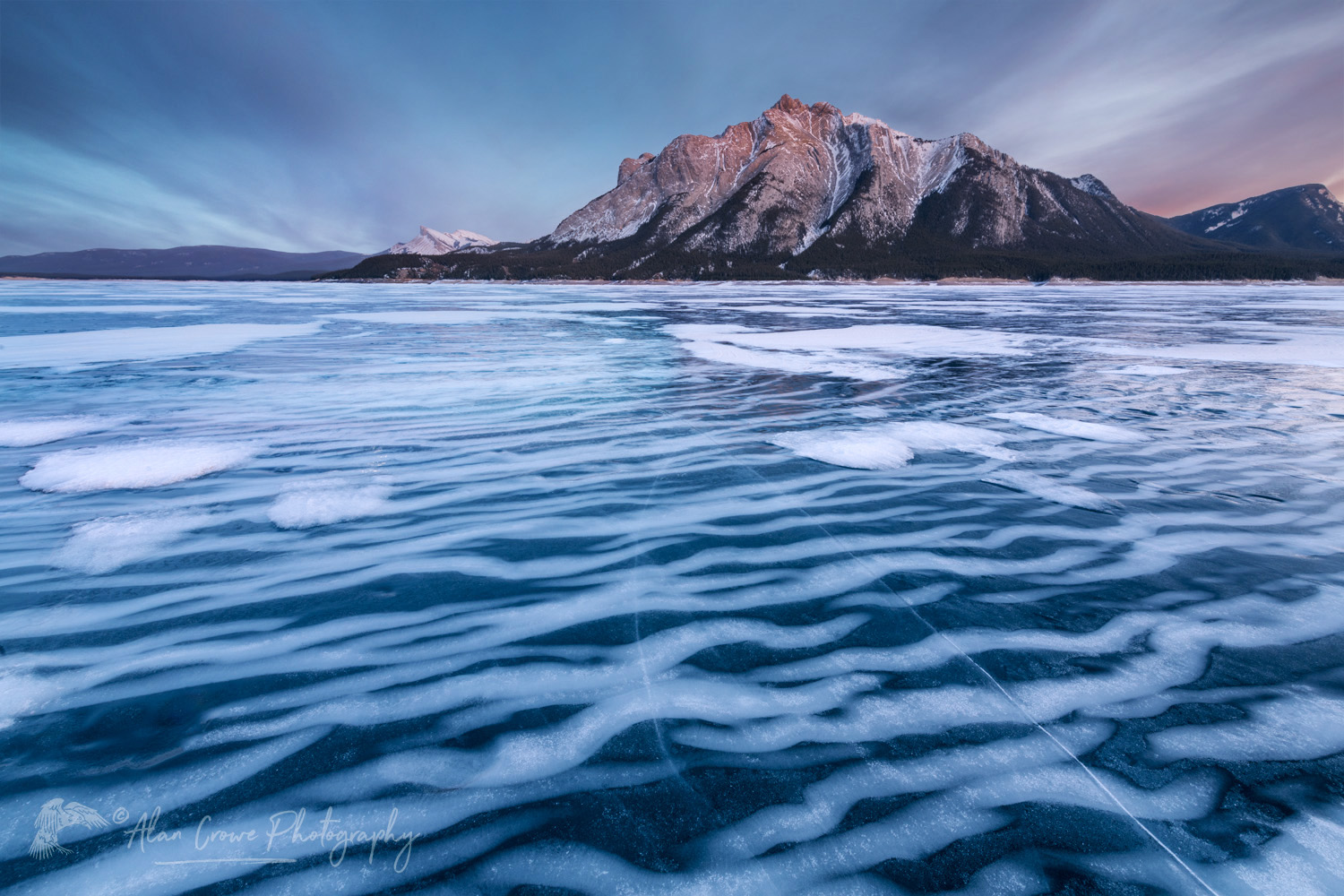 Striped patterns of snow frozen in the surface of Abraham Lake Alberta Canada #82390b